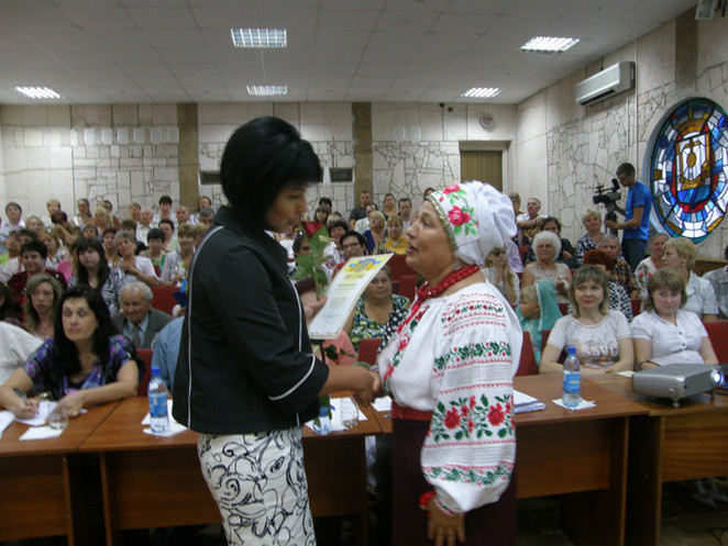 Наталья Иванцова вручает благодарственный лист участнице конкурса