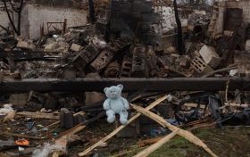 Children's toy on the background of ruins. Photo from open sources