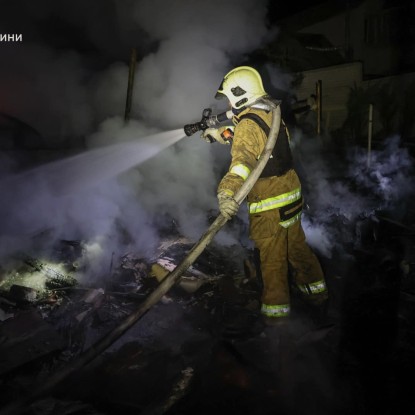 Rescuers work at the site of the attack in Kharkiv